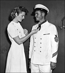 John's wife Alice admires his  newly awarded Medal of Honor.