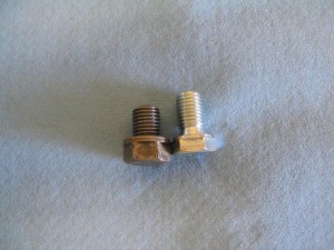 On the left is a stock KLR650 plug,  and on the right, an inexpensive,  low-profile plug from N.A.P.A..